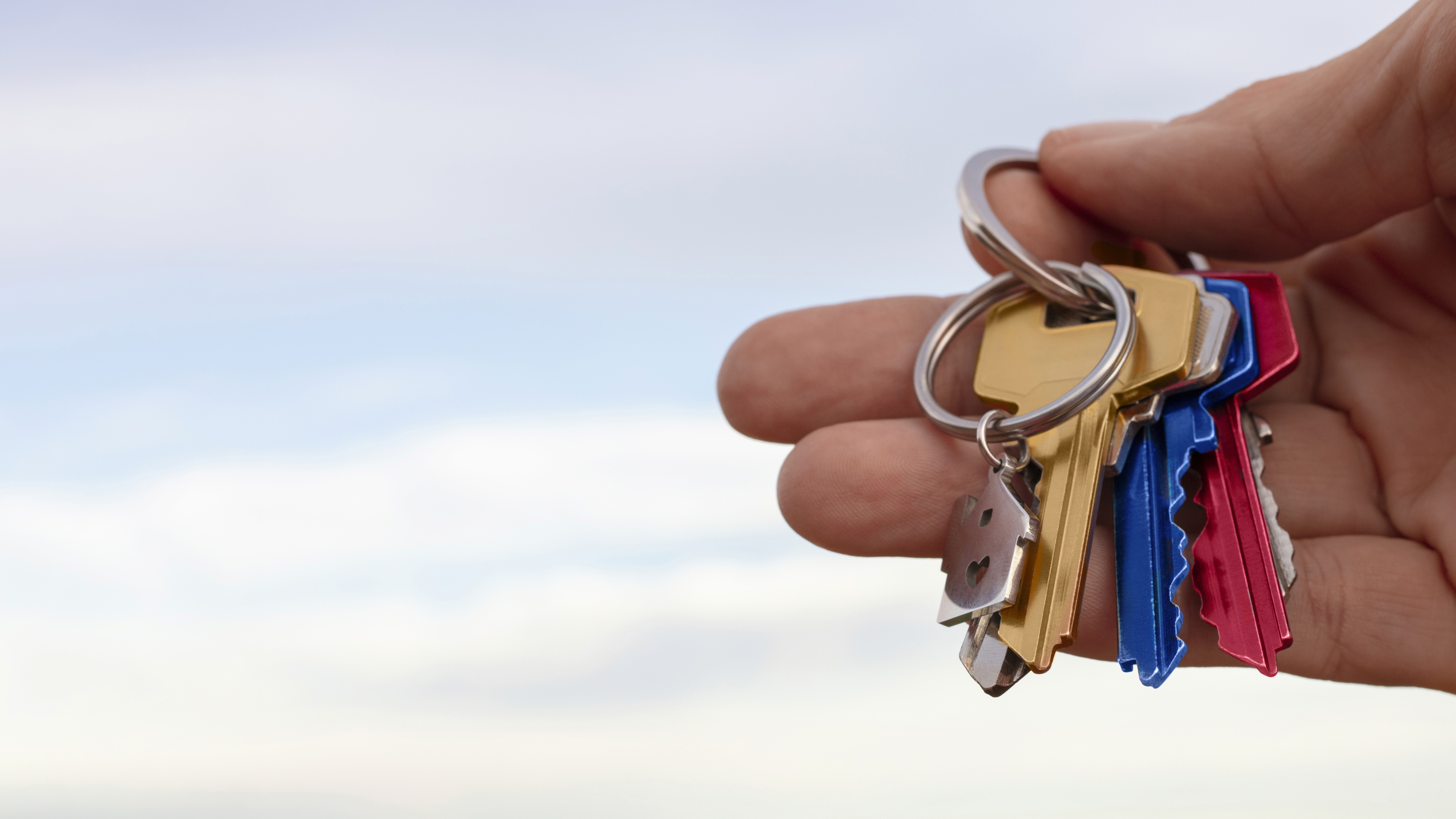 Hand holding colorful keys representing access and solutions